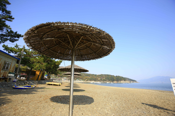 Relaxing beach stop on a South Korea guided motorcycle tour, with a quiet seaside view and coastal scenery.