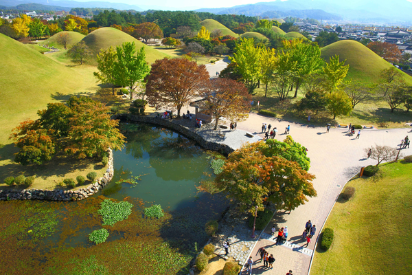 Ancient royal tomb park in Gyeongju, a cultural stop on a guided motorcycle tour in South Korea.