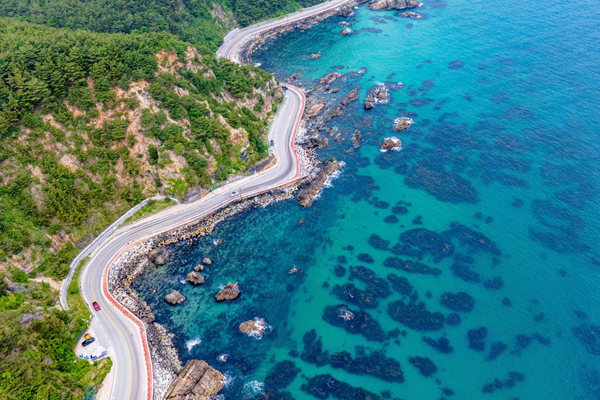 Scenic coastal road in South Korea with turquoise ocean views, featured on a guided motorcycle tour in Korea.